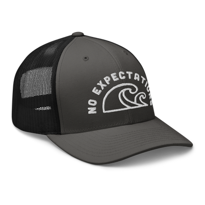 Unisex Embroidered Retro Trucker Hat featuring the No Expectations Wave logo on the front, part of the No Expectations brand collection Charcoal